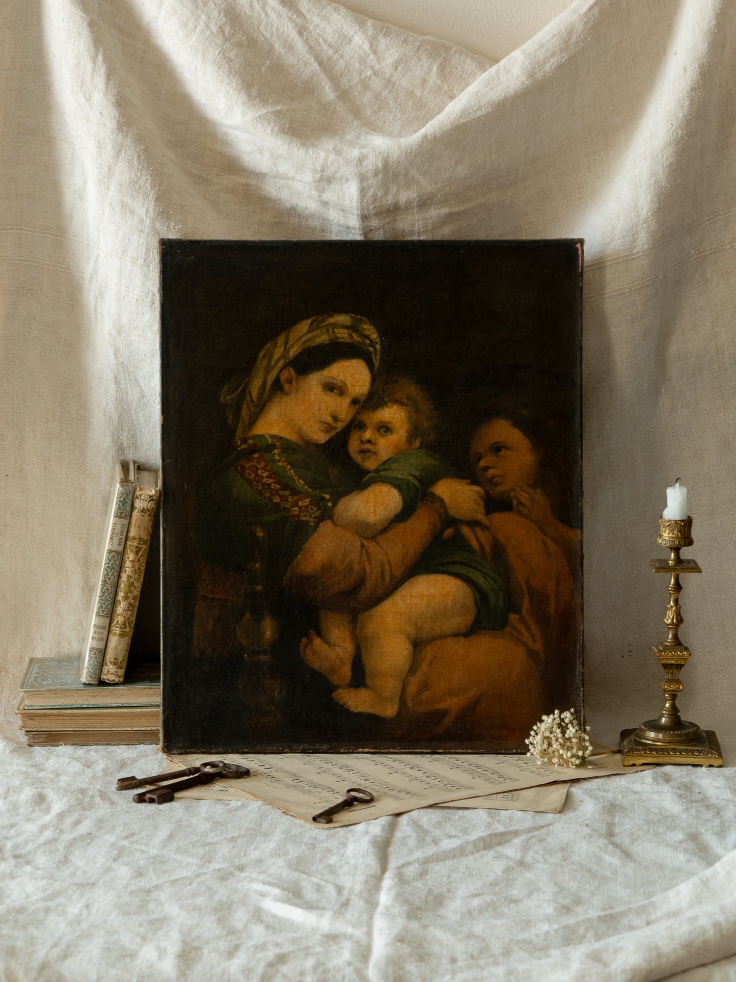 A late 19th-century/early 20th century after Raphael oil painting based on Madonna della Sedia (1513–1514, Pitti Palace, Florence). The artist (perhaps a student of the time) adapts Raphael’s tondo into a rectangular canvas, preserving the iconic green dress with patterned sleeve, the tender embrace, and the young St. John at right against a deep ground.