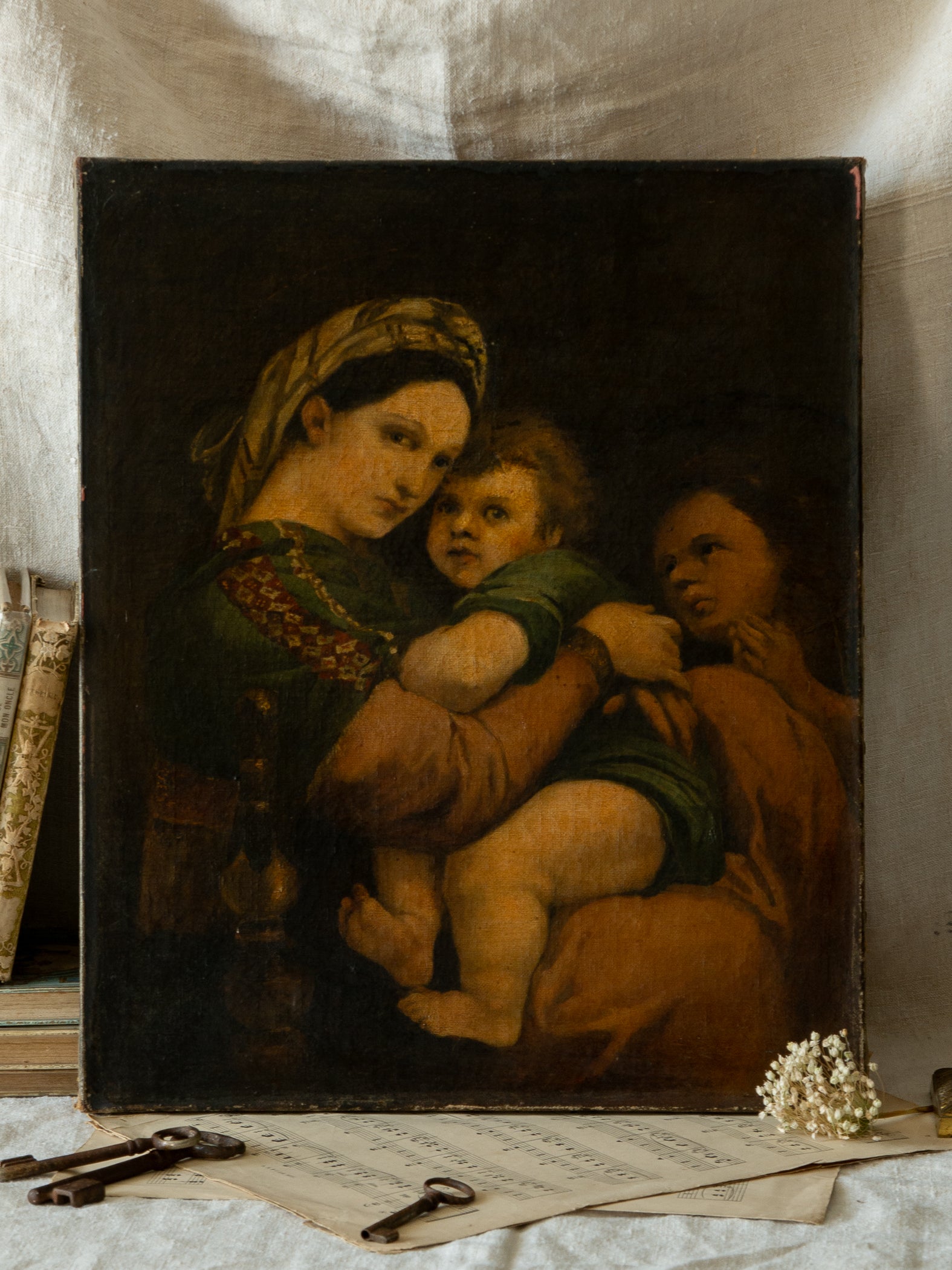 A late 19th-century/early 20th century after Raphael oil painting based on Madonna della Sedia (1513–1514, Pitti Palace, Florence). The artist (perhaps a student of the time) adapts Raphael’s tondo into a rectangular canvas, preserving the iconic green dress with patterned sleeve, the tender embrace, and the young St. John at right against a deep ground.