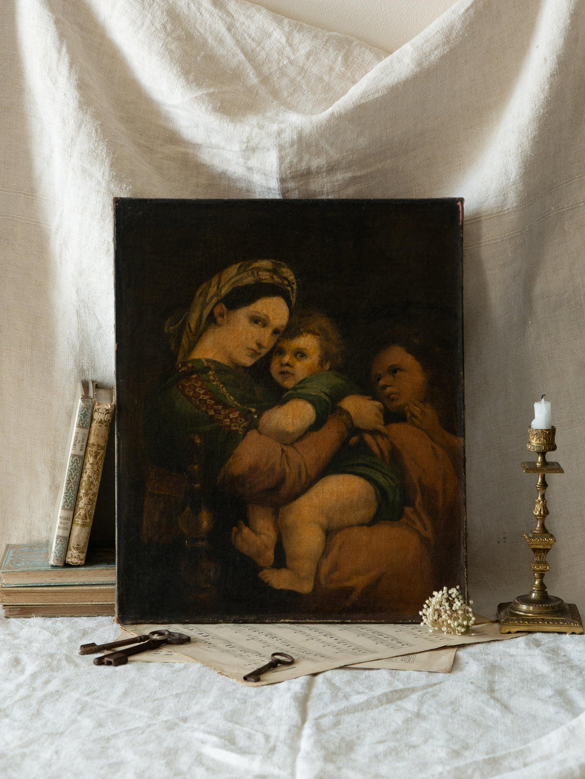 A late 19th-century/early 20th century after Raphael oil painting based on Madonna della Sedia (1513–1514, Pitti Palace, Florence). The artist (perhaps a student of the time) adapts Raphael’s tondo into a rectangular canvas, preserving the iconic green dress with patterned sleeve, the tender embrace, and the young St. John at right against a deep ground.