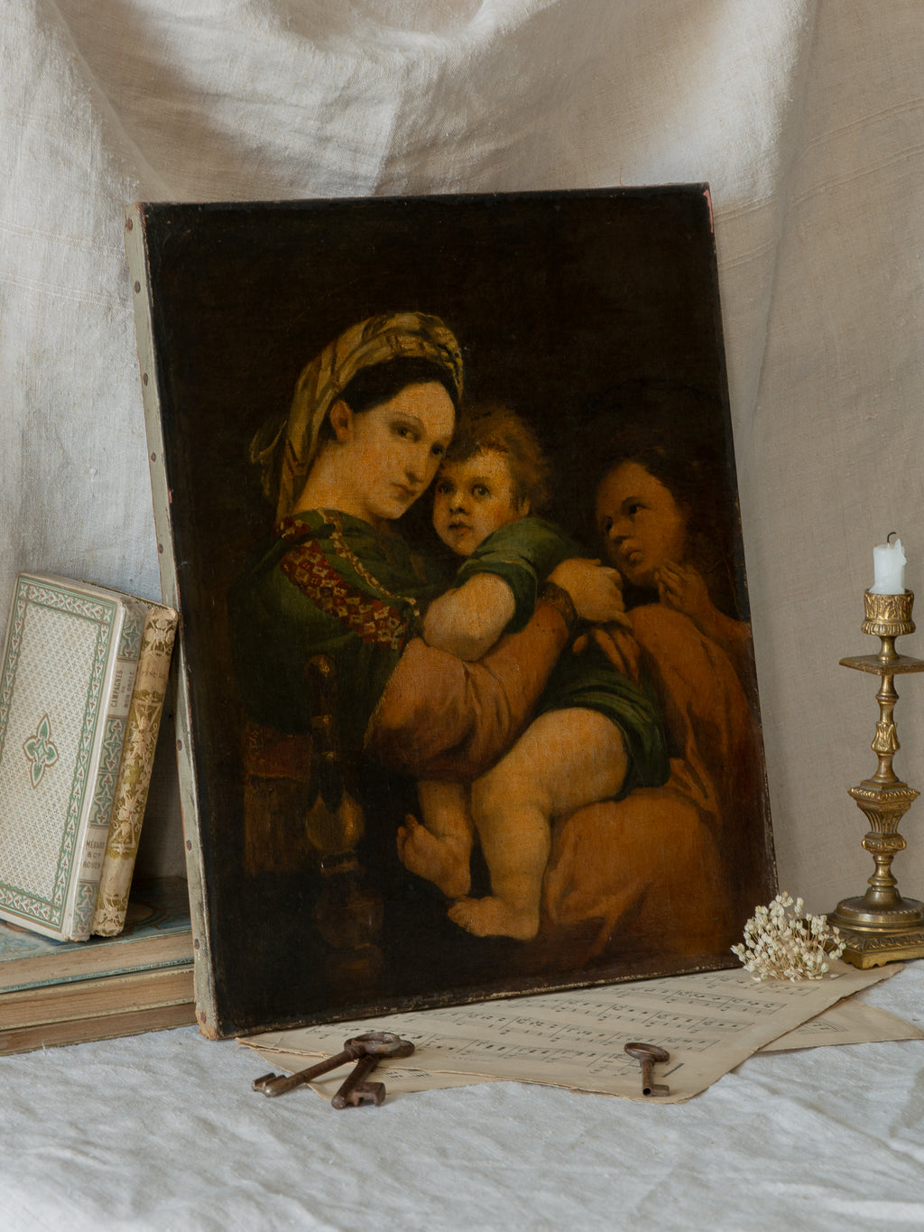 A late 19th-century/early 20th century after Raphael oil painting based on Madonna della Sedia (1513–1514, Pitti Palace, Florence). The artist (perhaps a student of the time) adapts Raphael’s tondo into a rectangular canvas, preserving the iconic green dress with patterned sleeve, the tender embrace, and the young St. John at right against a deep ground.