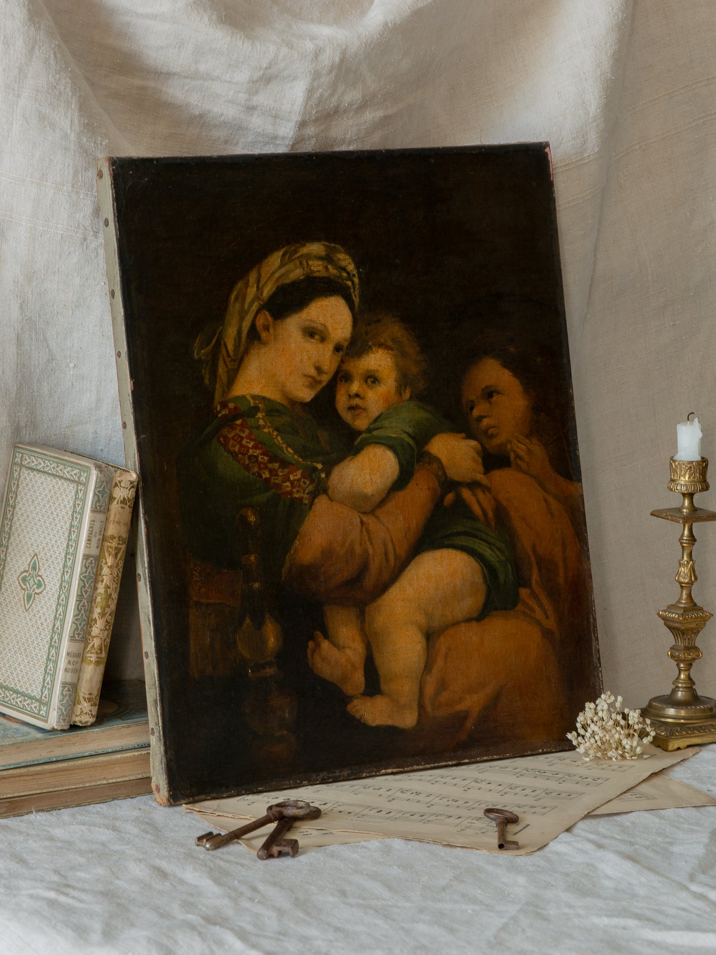 A late 19th-century/early 20th century after Raphael oil painting based on Madonna della Sedia (1513–1514, Pitti Palace, Florence). The artist (perhaps a student of the time) adapts Raphael’s tondo into a rectangular canvas, preserving the iconic green dress with patterned sleeve, the tender embrace, and the young St. John at right against a deep ground.
