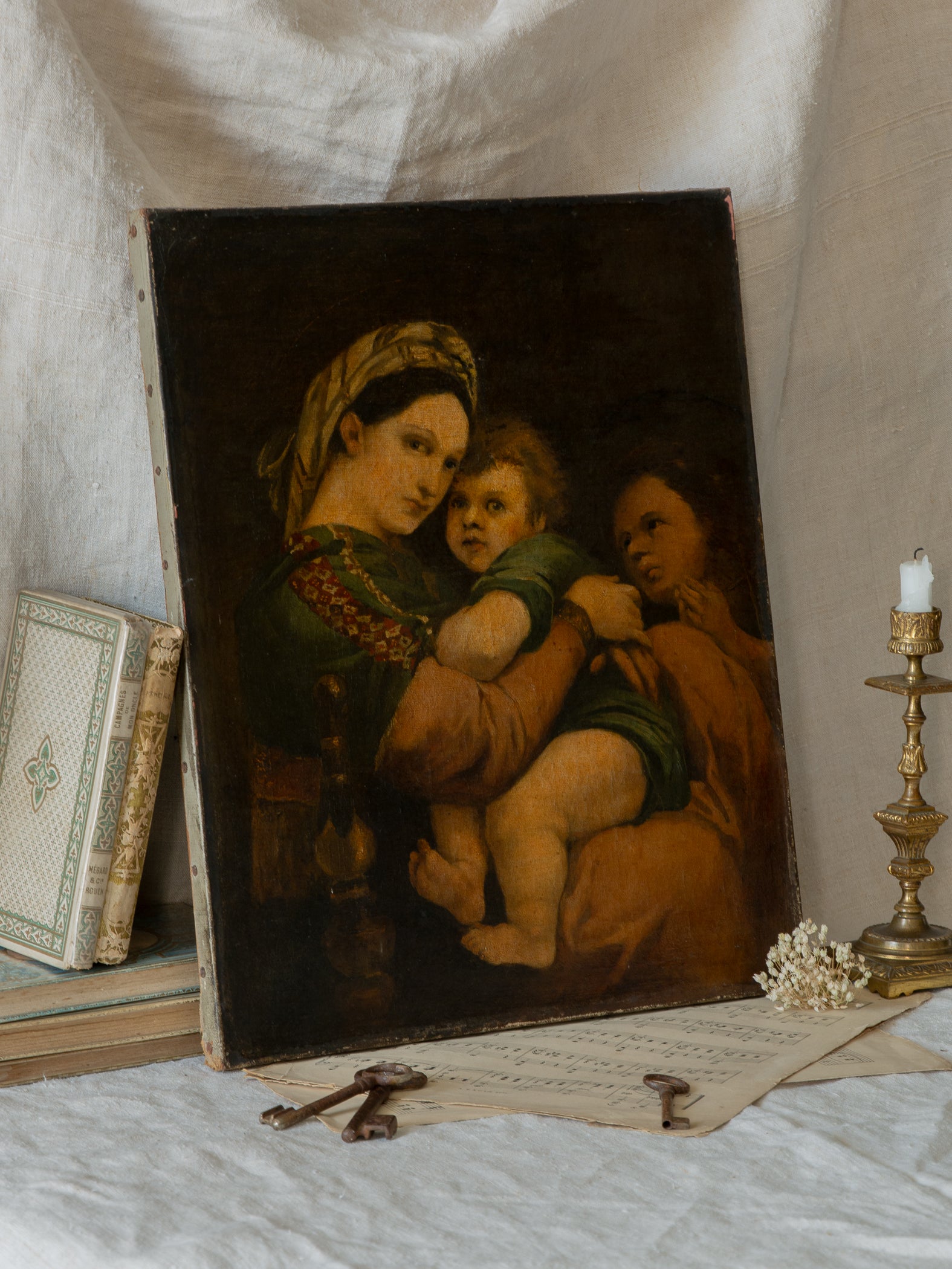 A late 19th-century/early 20th century after Raphael oil painting based on Madonna della Sedia (1513–1514, Pitti Palace, Florence). The artist (perhaps a student of the time) adapts Raphael’s tondo into a rectangular canvas, preserving the iconic green dress with patterned sleeve, the tender embrace, and the young St. John at right against a deep ground.