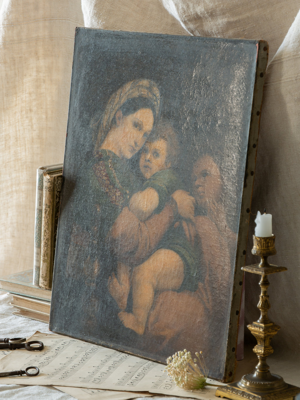 A late 19th-century/early 20th century after Raphael oil painting based on Madonna della Sedia (1513–1514, Pitti Palace, Florence). The artist (perhaps a student of the time) adapts Raphael’s tondo into a rectangular canvas, preserving the iconic green dress with patterned sleeve, the tender embrace, and the young St. John at right against a deep ground.