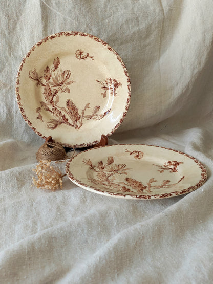 Two ceramic plates with floral patterns on a textured fabric background