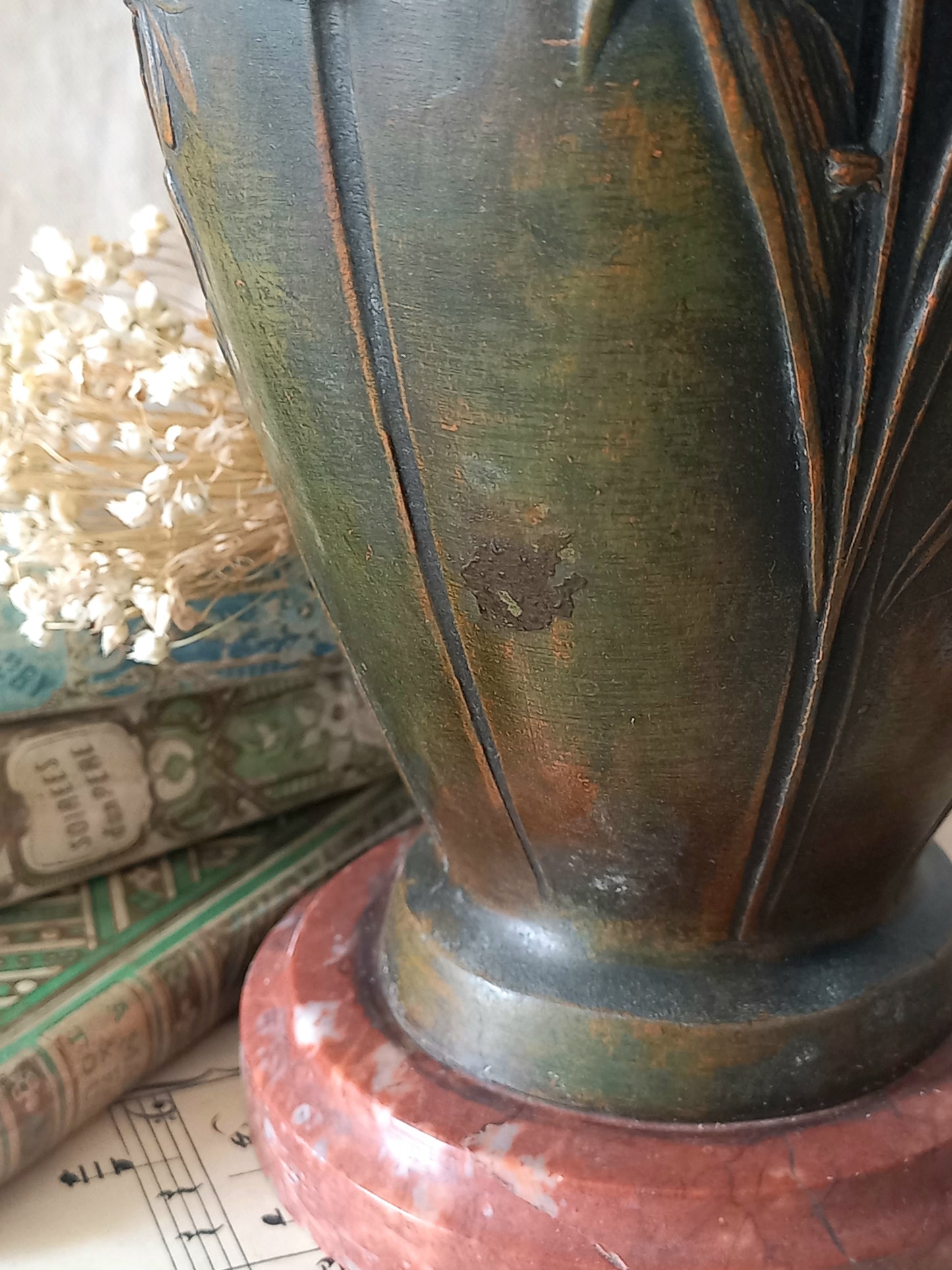 A stunning pair of decorative art nouveau vase/urn ornaments made from metal and finished in a stunning shade of green depicting organic floral decoration in relief.