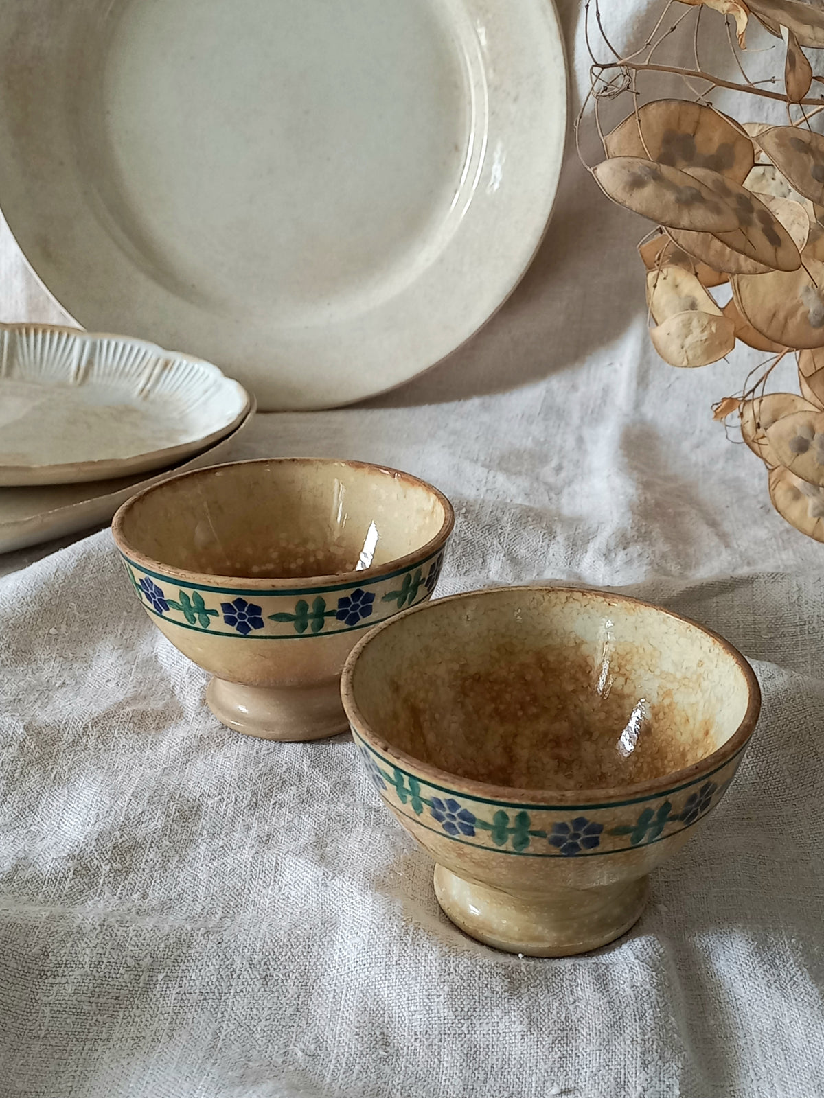 Two ceramic bowls with decorative blue patterns on a textured surface.