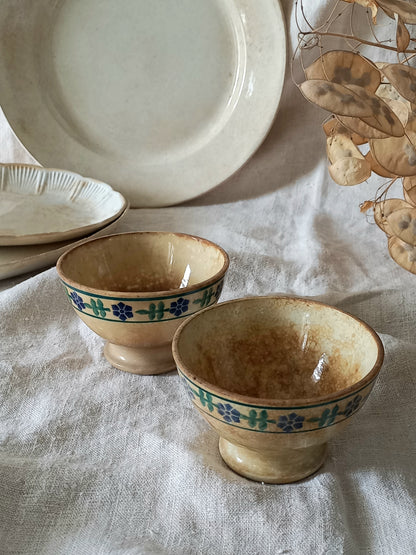 Two ceramic bowls with decorative blue patterns on a textured surface.