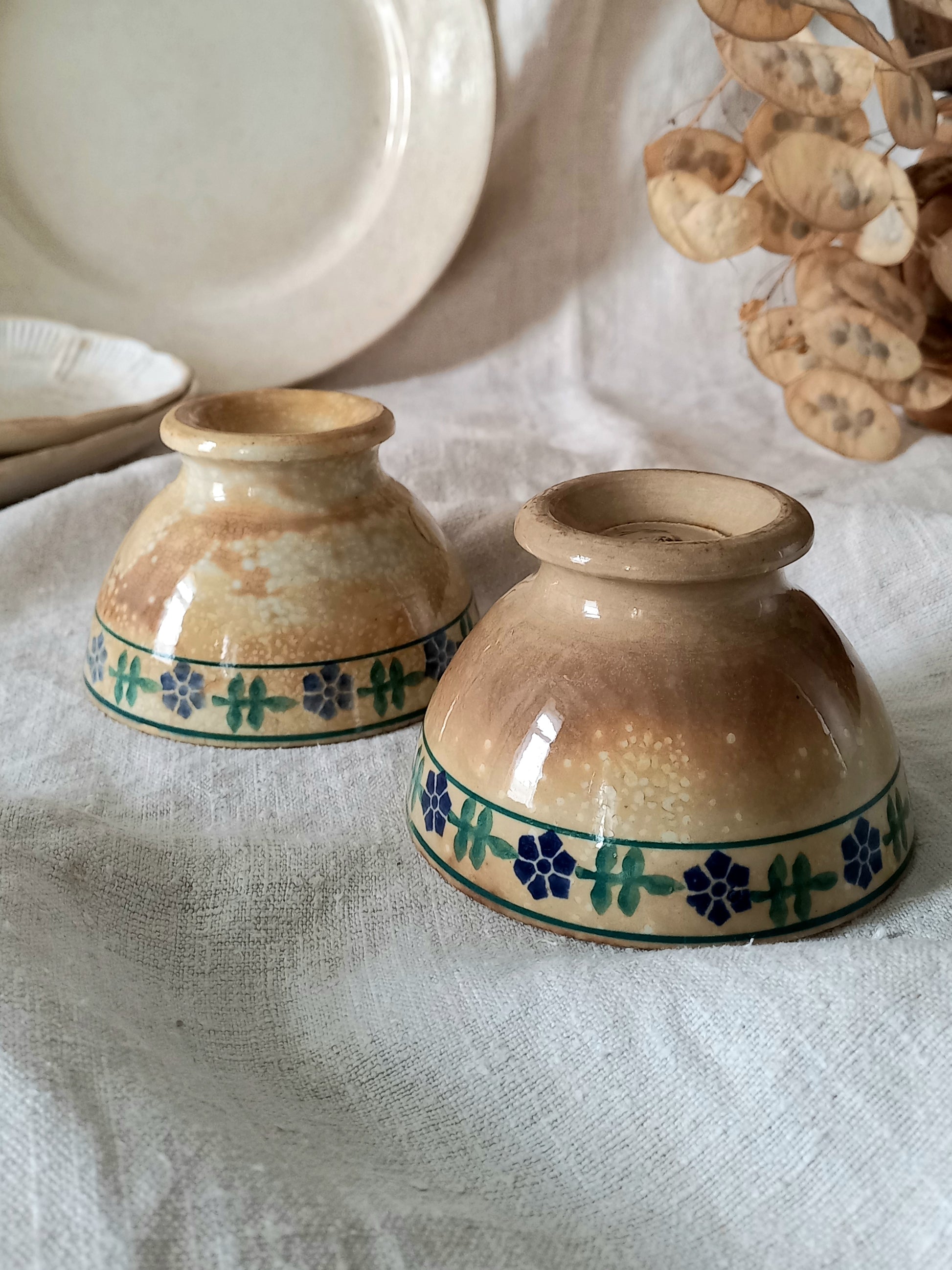 Two ceramic bowls with decorative patterns on a textured surface