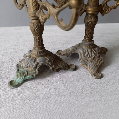 A pair of small vintage antique metal candelabras. This pair of decorative candle stick holders will give that touch of French shabby chic to any interior.