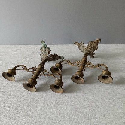 A pair of small vintage antique metal candelabras. This pair of decorative candle stick holders will give that touch of French shabby chic to any interior.