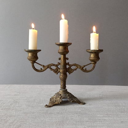 A pair of small vintage antique metal candelabras. This pair of decorative candle stick holders will give that touch of French shabby chic to any interior.