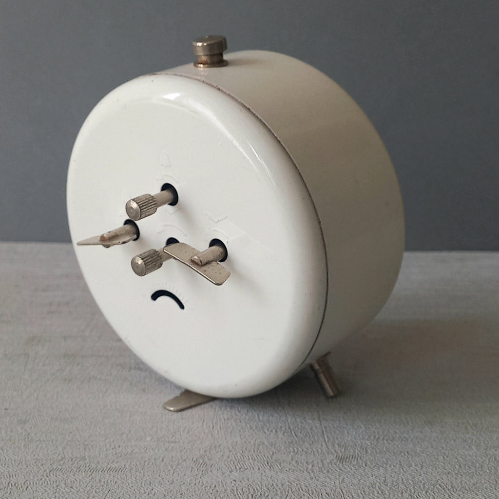 A wonderful vintage alarm clock in an eye-catching white and pink color scheme. This old clock is in working condition including the alarm and has a nice soothing ticking sound too. A great piece of European history from the former country of Czechoslovakia.
