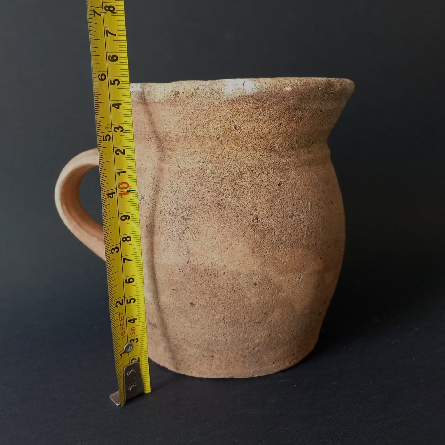 Small rustic vintage pottery jug with ochre glazed interior from France