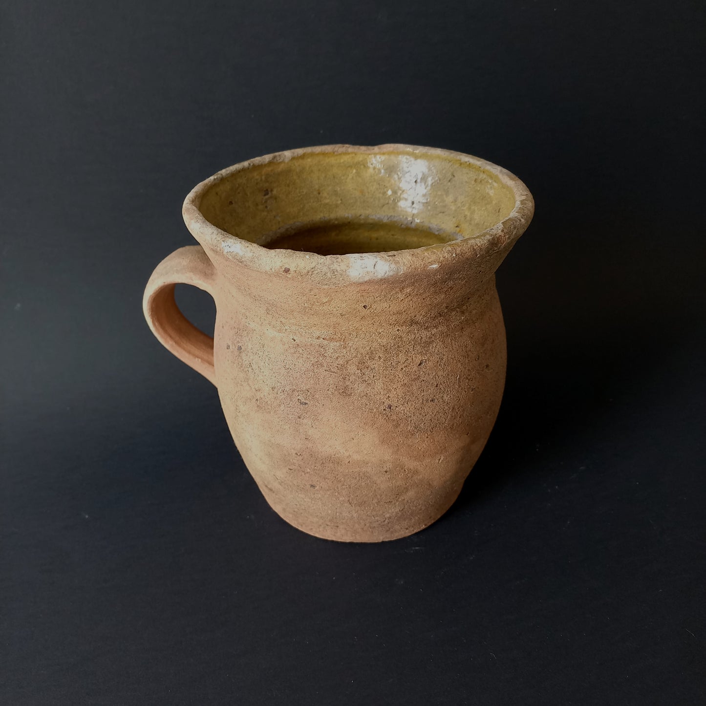 Small rustic vintage pottery jug with ochre glazed interior from France