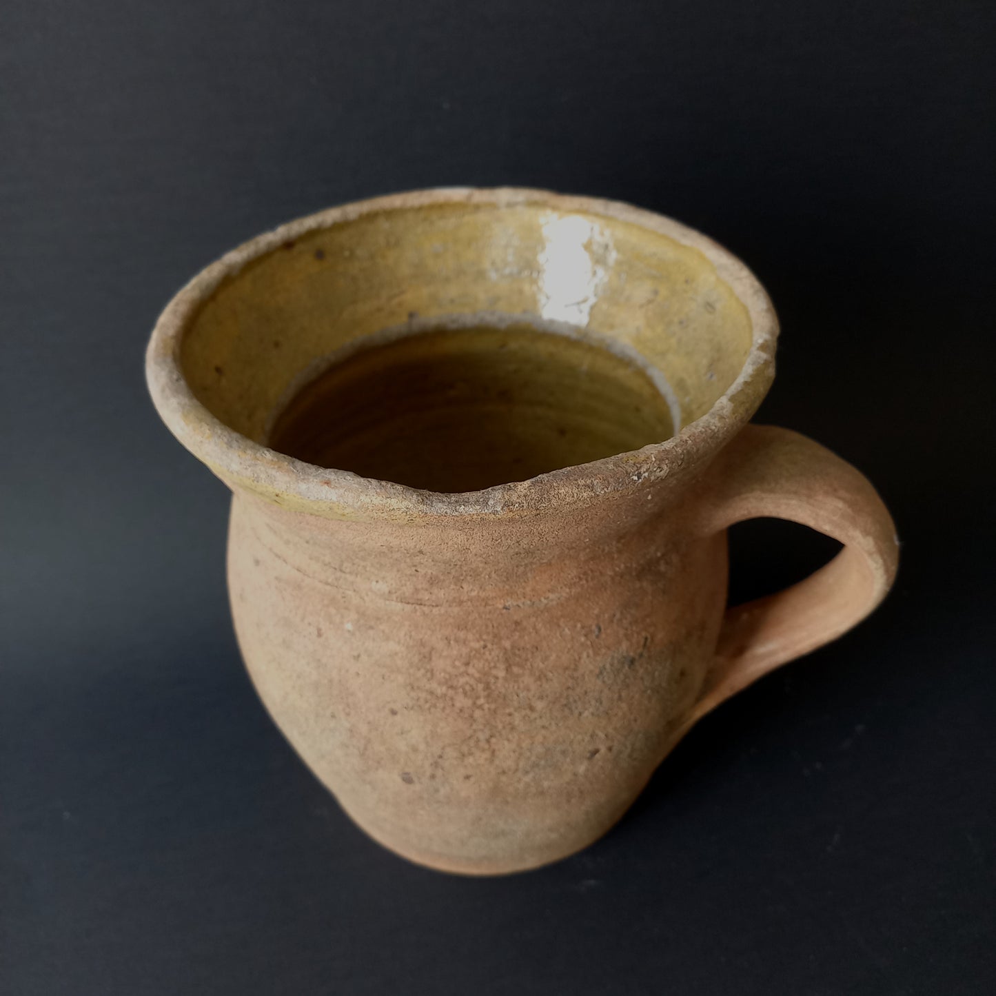 Small rustic vintage pottery jug with ochre glazed interior from France