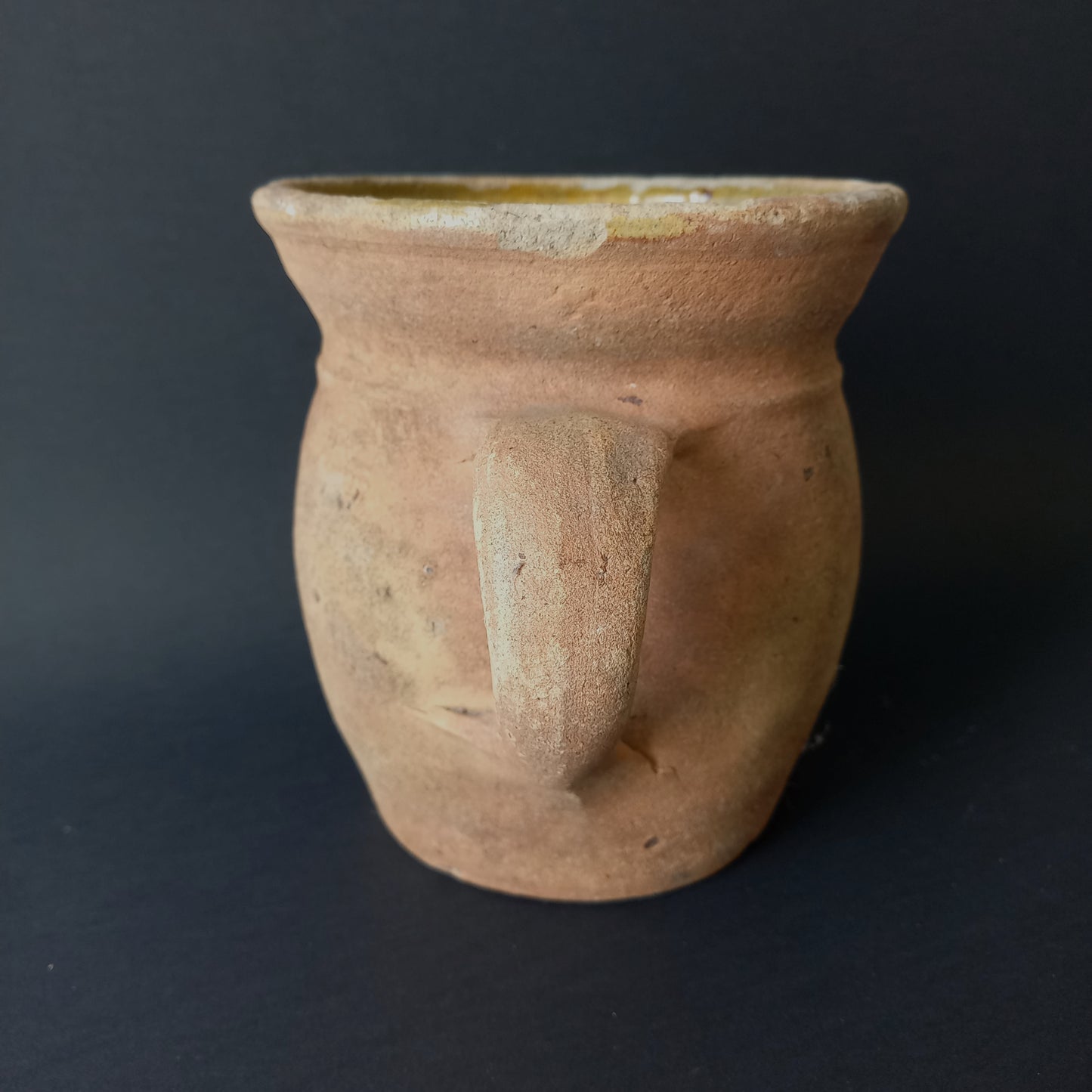 Small rustic vintage pottery jug with ochre glazed interior from France