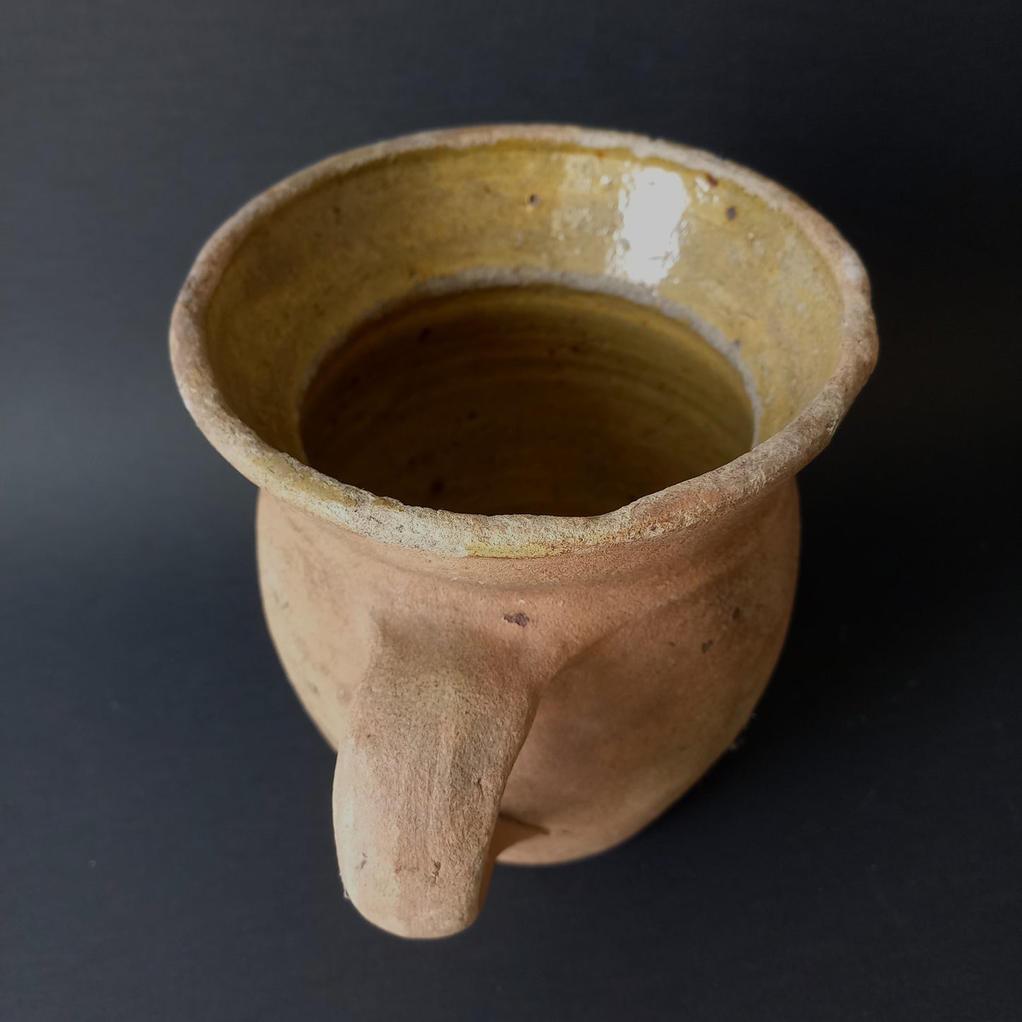 Small rustic vintage pottery jug with ochre glazed interior from France