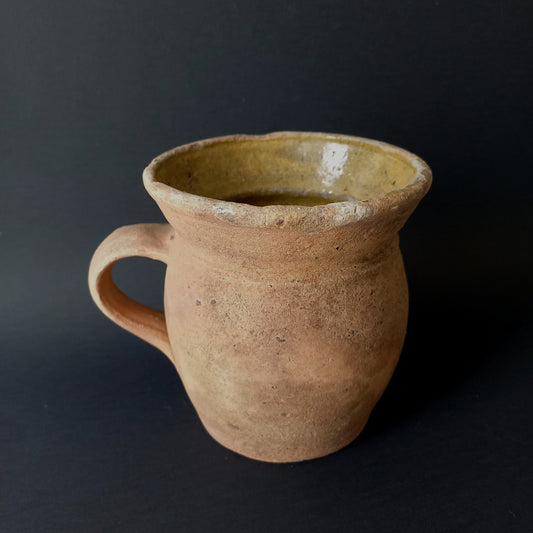 Small rustic vintage pottery jug with ochre glazed interior from France