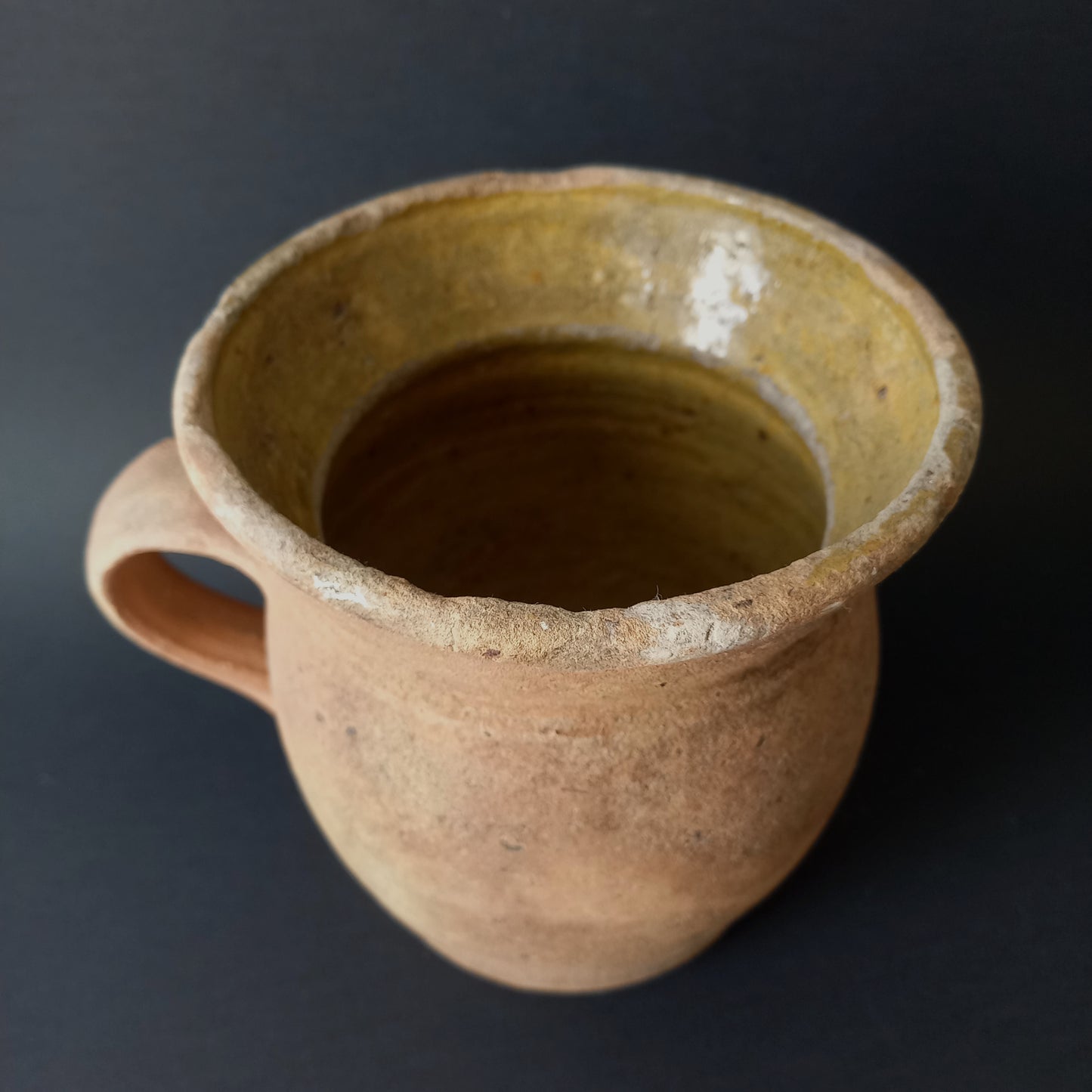 Small rustic vintage pottery jug with ochre glazed interior from France