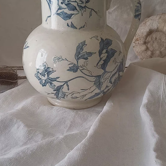 A large and beautiful French antique ironstone jug in a lovely aged white with blue floral transfer pattern. This wonderful piece of ironstone history has a super patina of age that gives it that look we all admire.