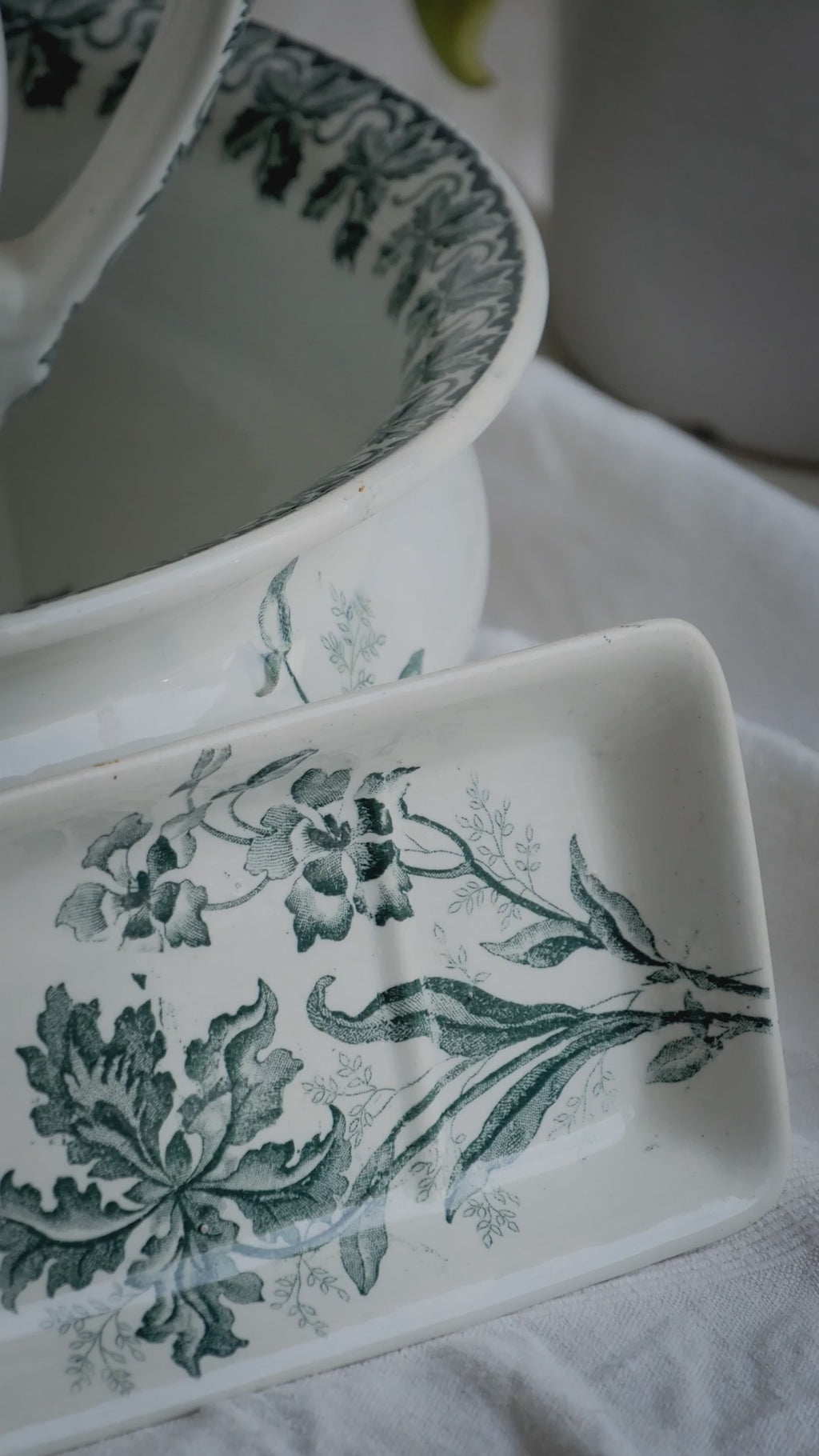 A French antique ironstone jug, basin and soap dish, printed in a soft teal-green bird-and-floral pattern. 