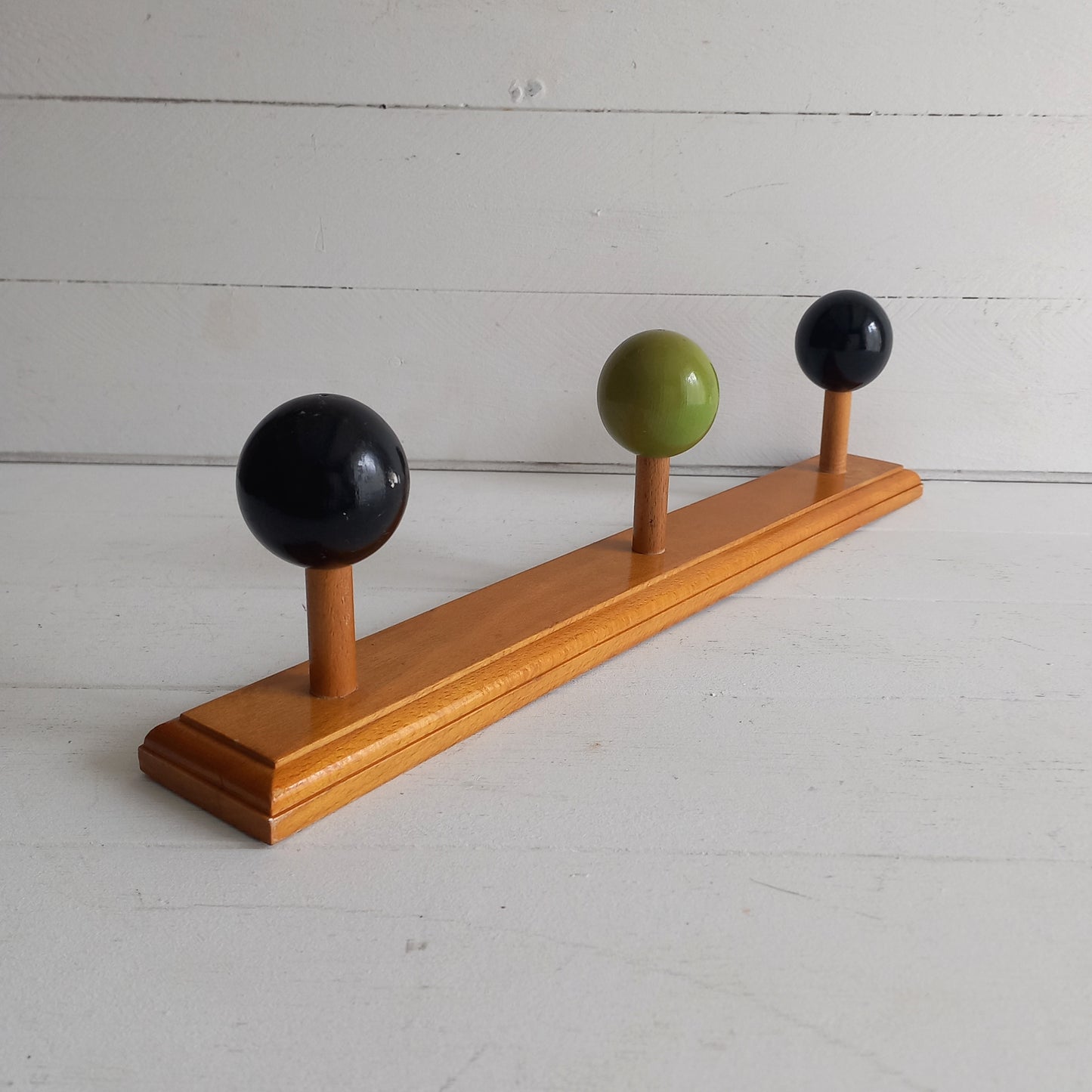 Vintage wooden coat rack with green and black pegs from France, retro wall mounted coat hanger