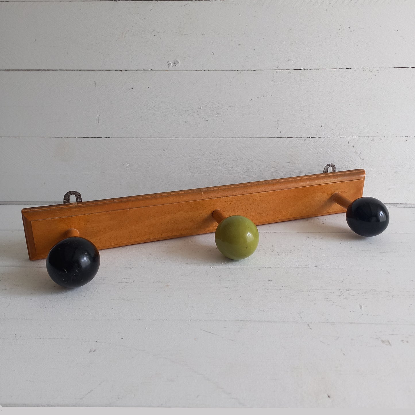 Vintage wooden coat rack with green and black pegs from France, retro wall mounted coat hanger