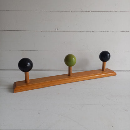 Vintage wooden coat rack with green and black pegs from France, retro wall mounted coat hanger