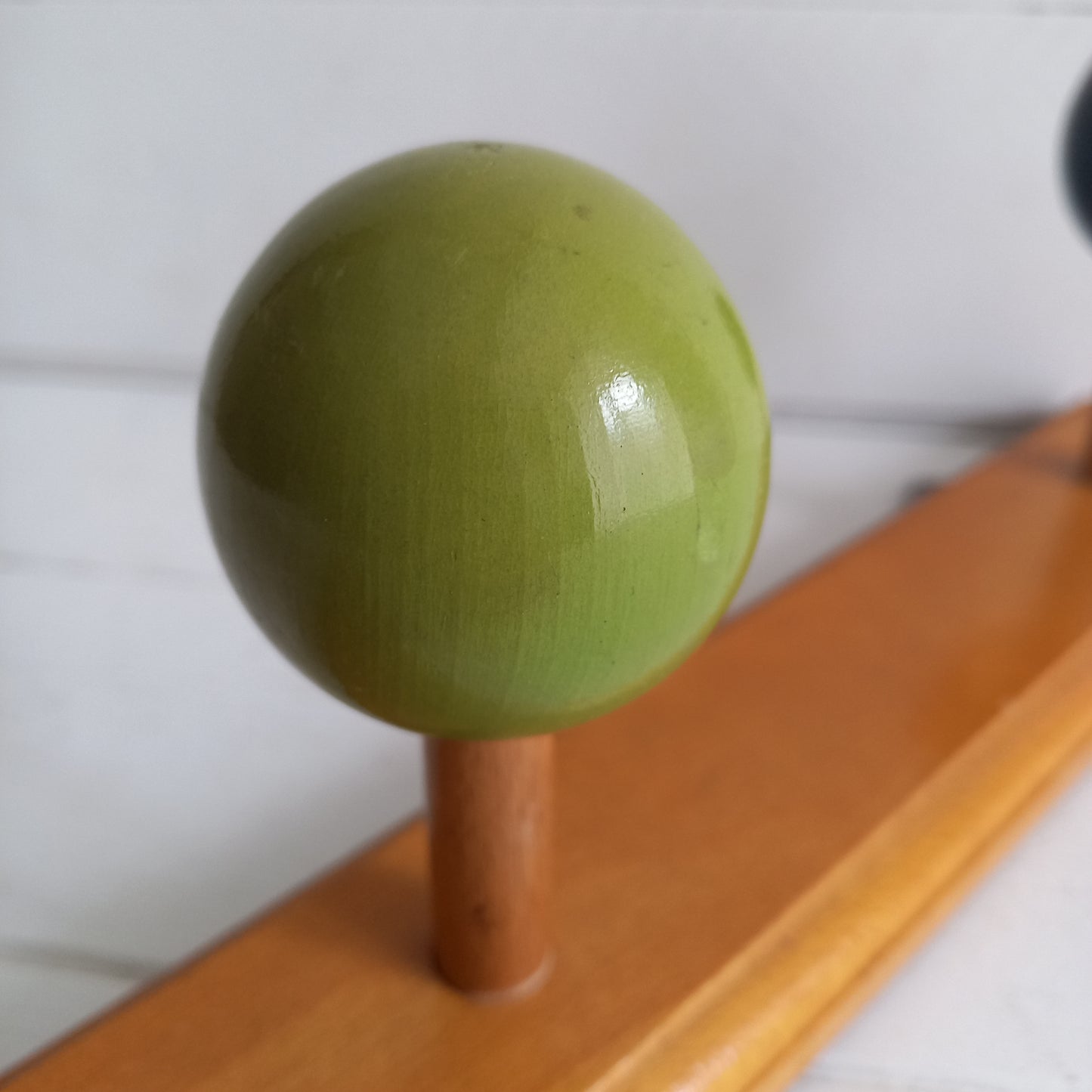 Vintage wooden coat rack with green and black pegs from France, retro wall mounted coat hanger