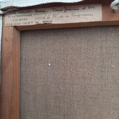 Back of a painting with artist's signature and contact information