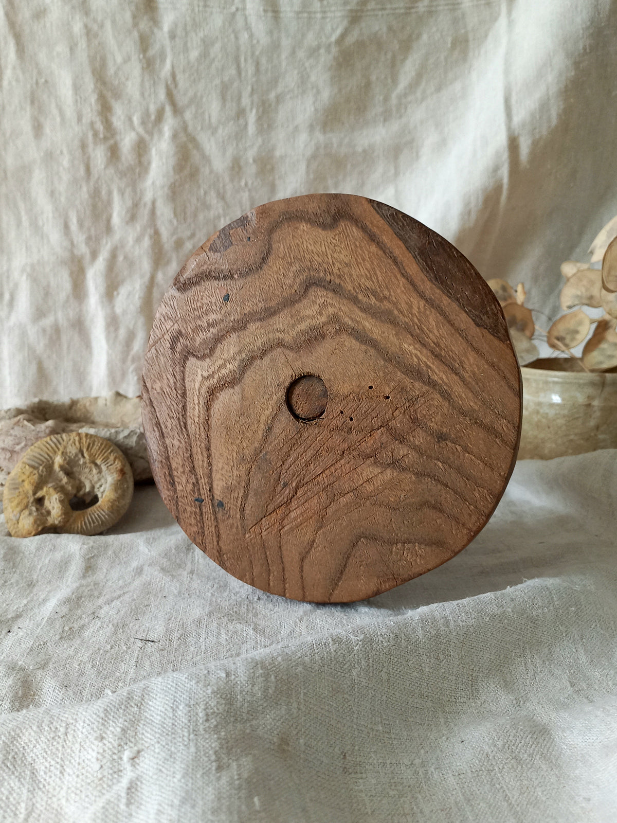 vintage wooden hat stand on a textured white fabric background