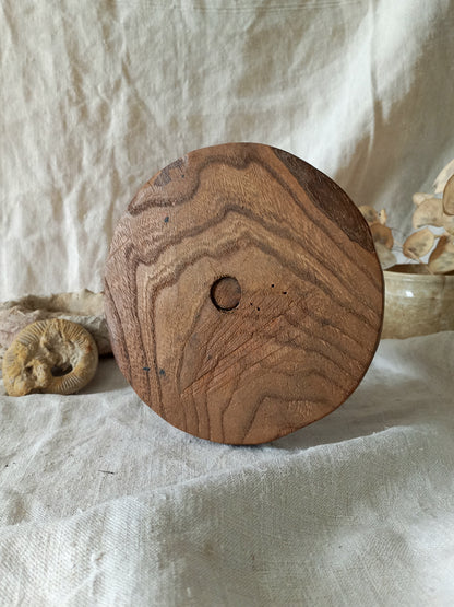 vintage wooden hat stand on a textured white fabric background