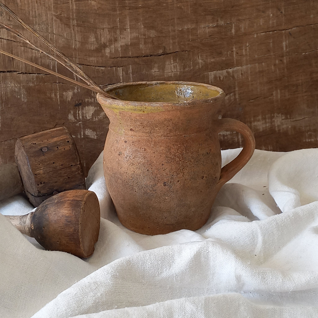 A little antique stoneware jug with a glazed interior in a wonderful shade of ochre, so rustic! This piece of pottery has aged beautifully and with its uneven worn edges and earthy rough texture it's perfect for a rustic, country or farmhouse interior.