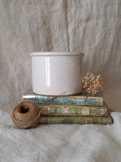 Antique jam pot on a textured surface
