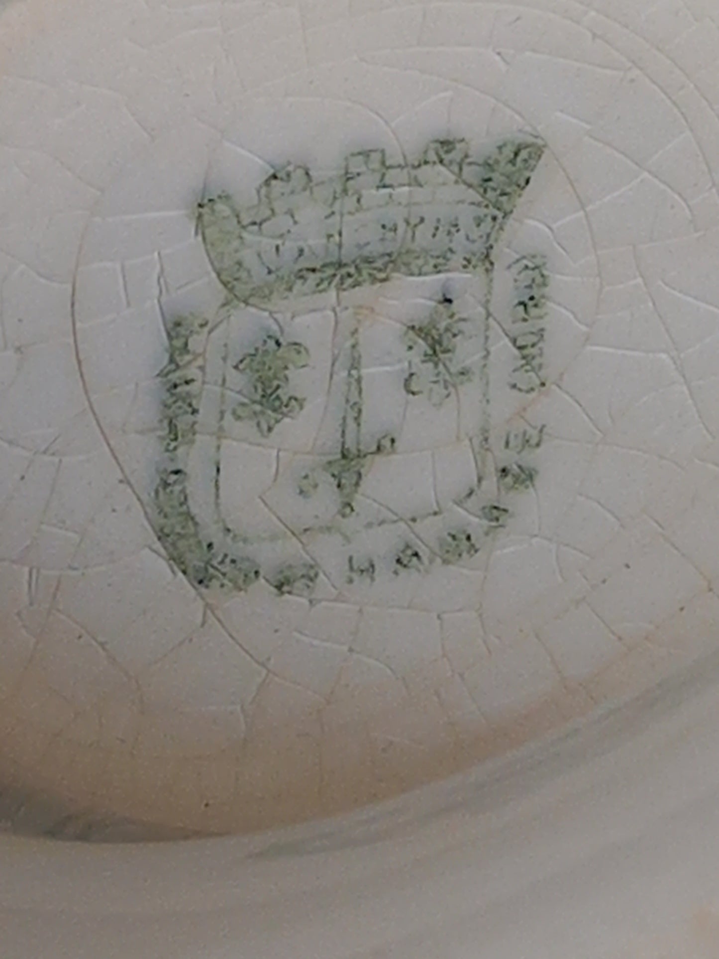 Maker's mark under an antique ironstone tureen