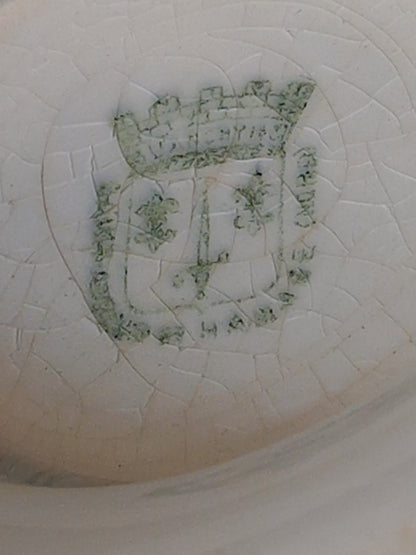 Maker's mark under an antique ironstone tureen