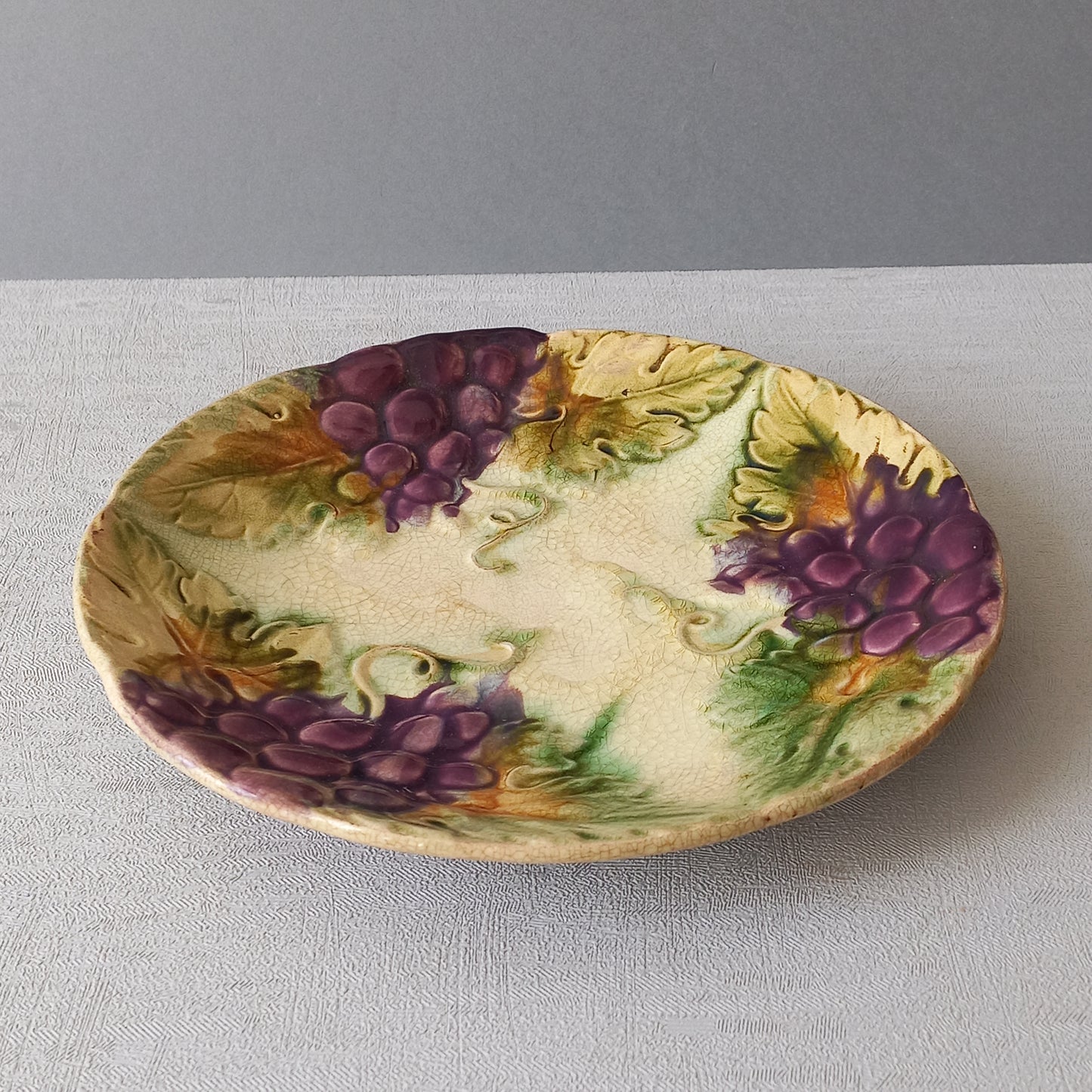 Small antique majolica wall plate with purple grapes from France, decorative home decor