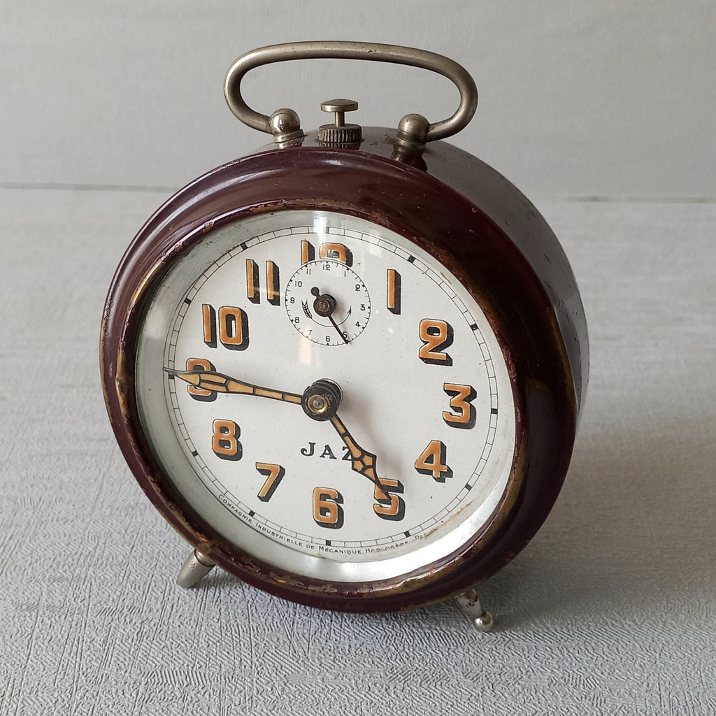 A handsome little vintage alarm clock by premier French manufacturer, Jaz.

This wonderful little clock is in semi-working condition including the alarm, although I should note that being an old time piece dating from the pre-1940 period he's temperamental and sometimes will just stop working, although all that's needed is a gentle shake from side to side and he will once more begin to tick - sometimes you might have to repeat this and have patience with him.