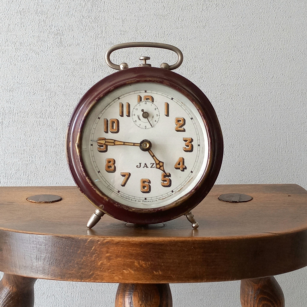 A handsome little vintage alarm clock by premier French manufacturer, Jaz.

This wonderful little clock is in semi-working condition including the alarm, although I should note that being an old time piece dating from the pre-1940 period he's temperamental and sometimes will just stop working, although all that's needed is a gentle shake from side to side and he will once more begin to tick - sometimes you might have to repeat this and have patience with him.