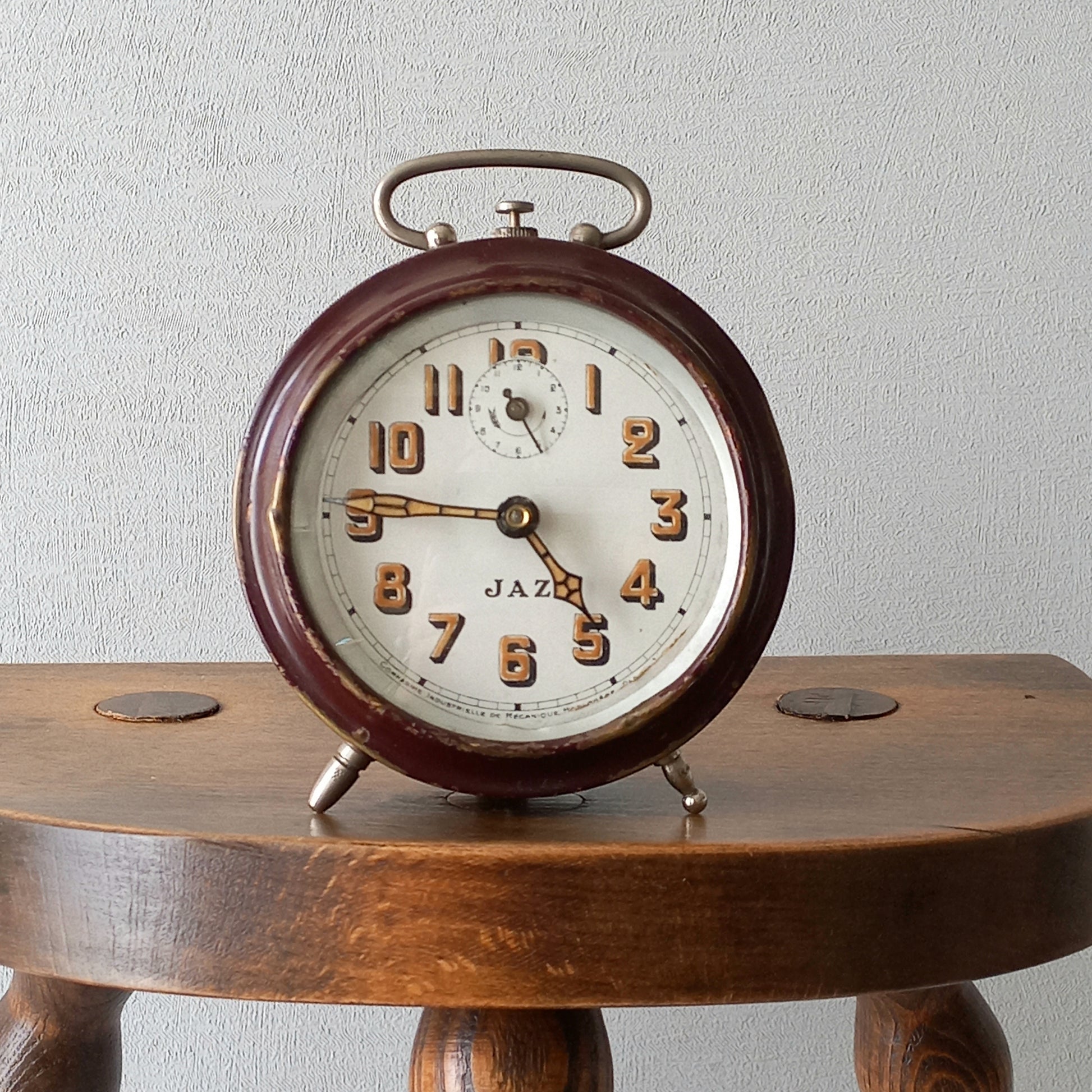 A handsome little vintage alarm clock by premier French manufacturer, Jaz.

This wonderful little clock is in semi-working condition including the alarm, although I should note that being an old time piece dating from the pre-1940 period he's temperamental and sometimes will just stop working, although all that's needed is a gentle shake from side to side and he will once more begin to tick - sometimes you might have to repeat this and have patience with him.