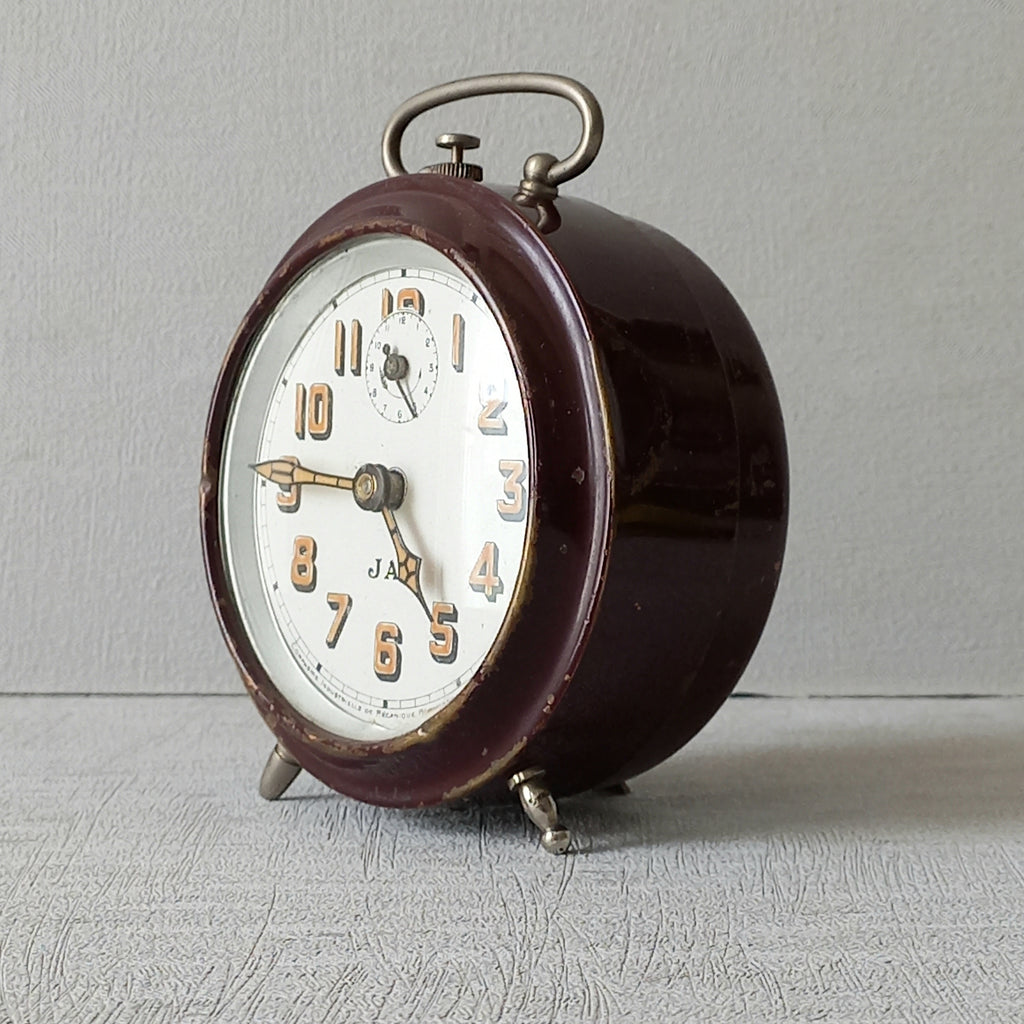 A handsome little vintage alarm clock by premier French manufacturer, Jaz.

This wonderful little clock is in semi-working condition including the alarm, although I should note that being an old time piece dating from the pre-1940 period he's temperamental and sometimes will just stop working, although all that's needed is a gentle shake from side to side and he will once more begin to tick - sometimes you might have to repeat this and have patience with him.