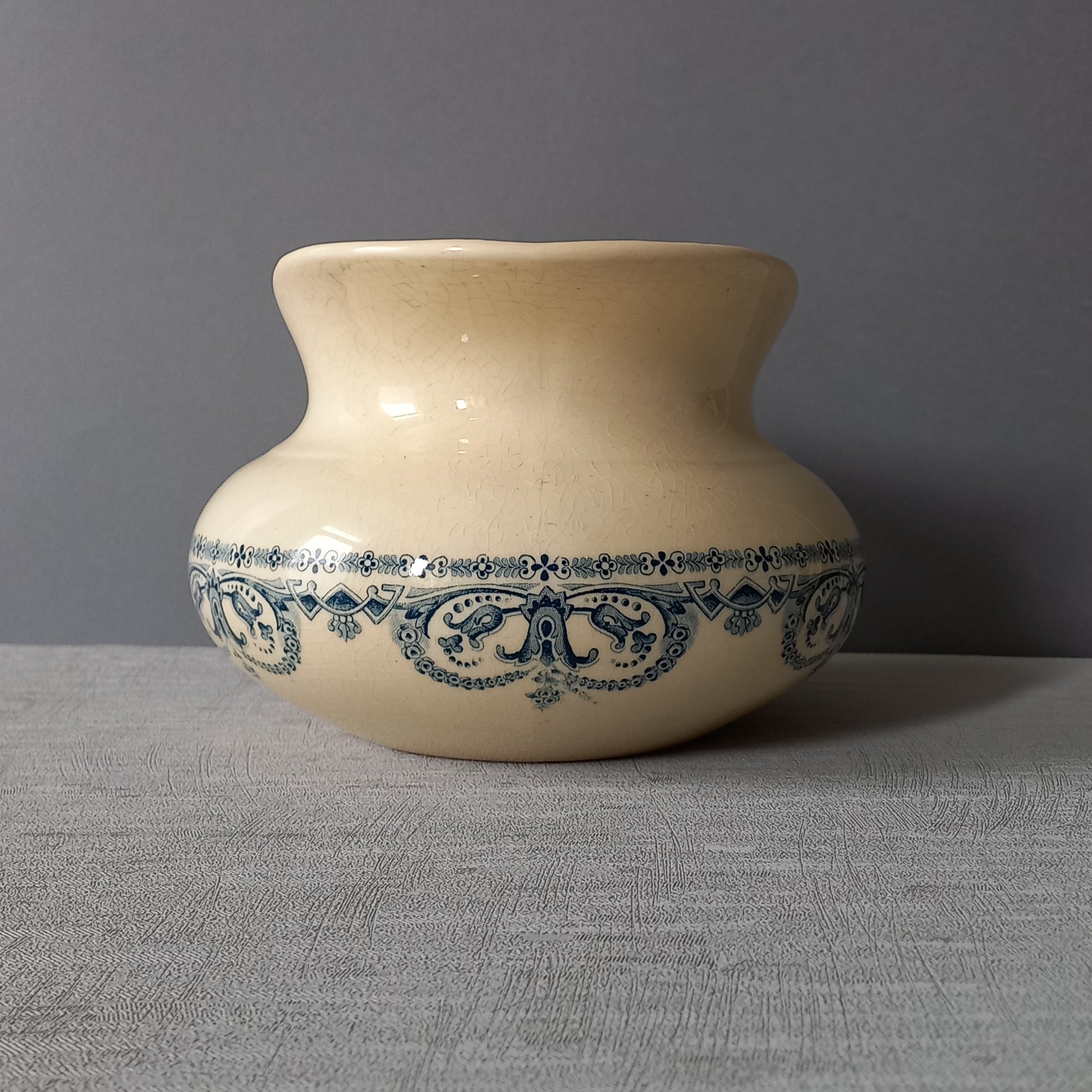 A beautiful French antique jug/pitcher, once used to pour water in a bowl for washing yourself, these days wonderful home decor - many people use them as bathroom decor.

This particular piece is in a lovely shade of off-white/cream with a dark blue transfer pattern - a very stylish and eye-catching piece of ironstone.