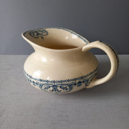 A beautiful French antique jug/pitcher, once used to pour water in a bowl for washing yourself, these days wonderful home decor - many people use them as bathroom decor.

This particular piece is in a lovely shade of off-white/cream with a dark blue transfer pattern - a very stylish and eye-catching piece of ironstone.