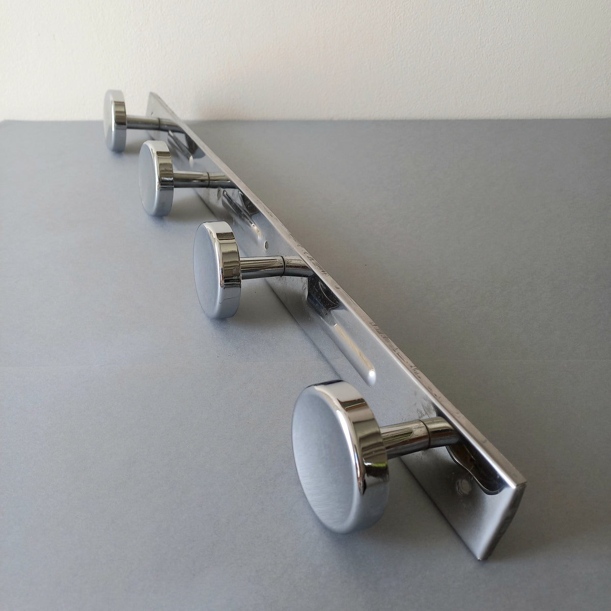 A stylish French vintage 4 peg metal coat rack with a polished finish, a great piece of practical wall decor for your home.