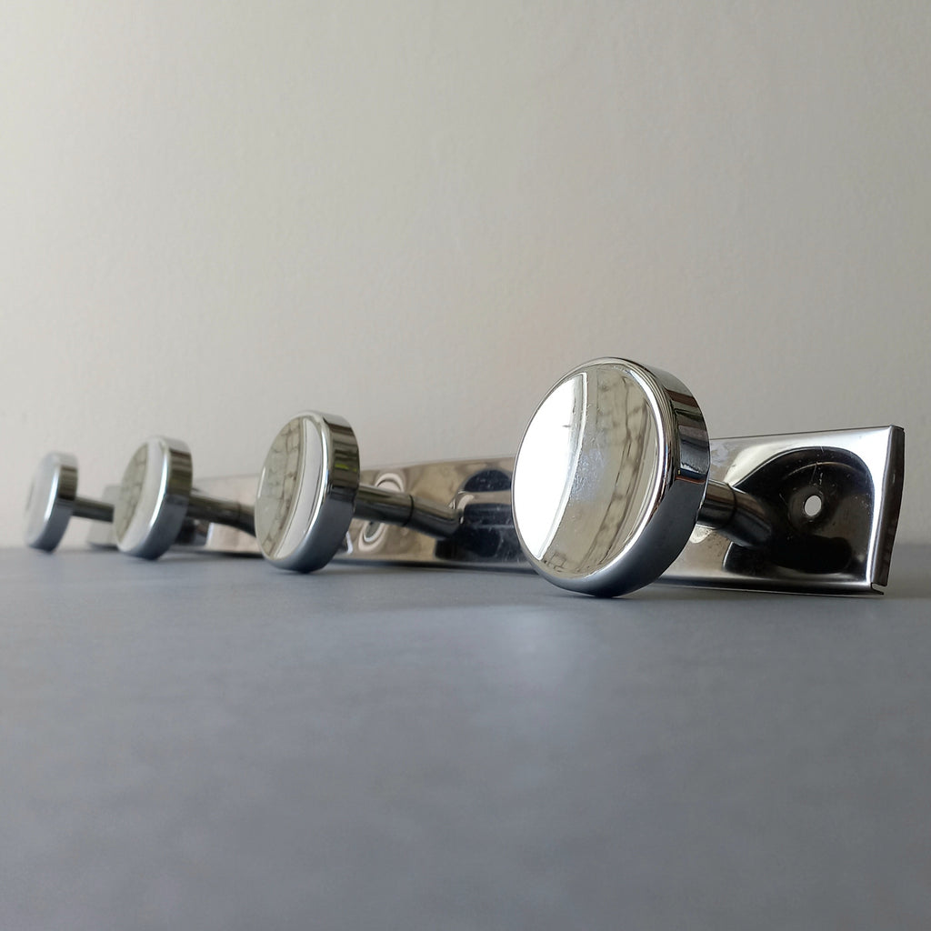 A stylish French vintage 4 peg metal coat rack with a polished finish, a great piece of practical wall decor for your home.