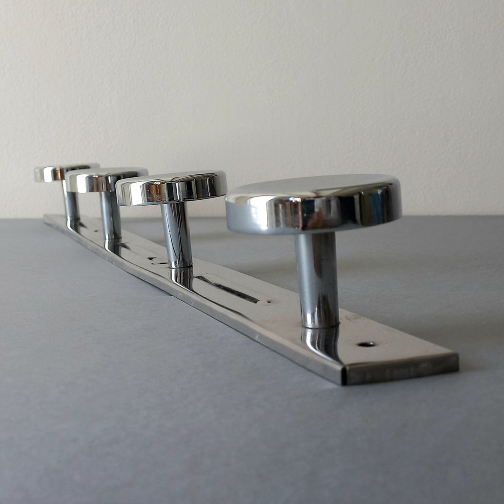 A stylish French vintage 4 peg metal coat rack with a polished finish, a great piece of practical wall decor for your home.