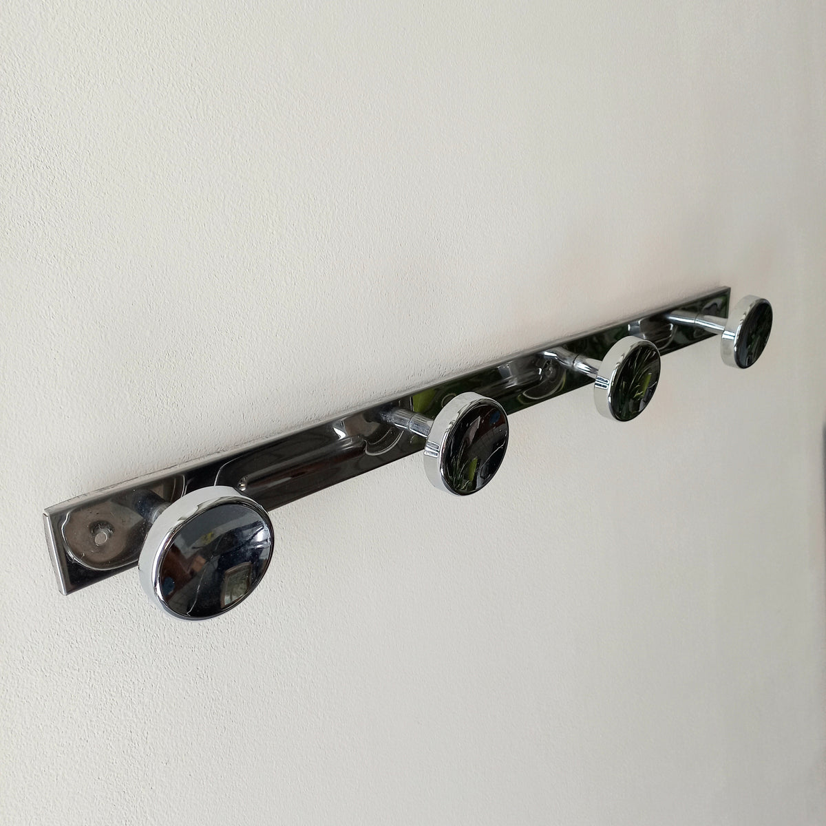 A stylish French vintage 4 peg metal coat rack with a polished finish, a great piece of practical wall decor for your home.
