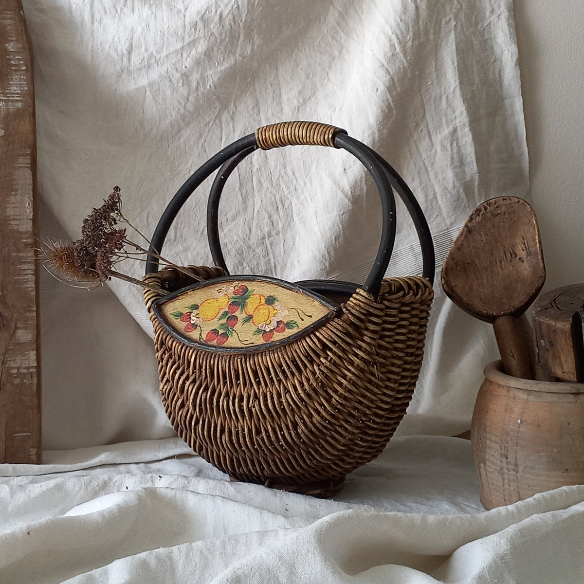 A vintage wicker shopping basket with a small wooden panel on each side with hand-painted fruit - so pretty!

This hand-made piece is full of rustic charm and offers many decorative possibilities to any interior, particularly those of a country, rustic or farmhouse nature.