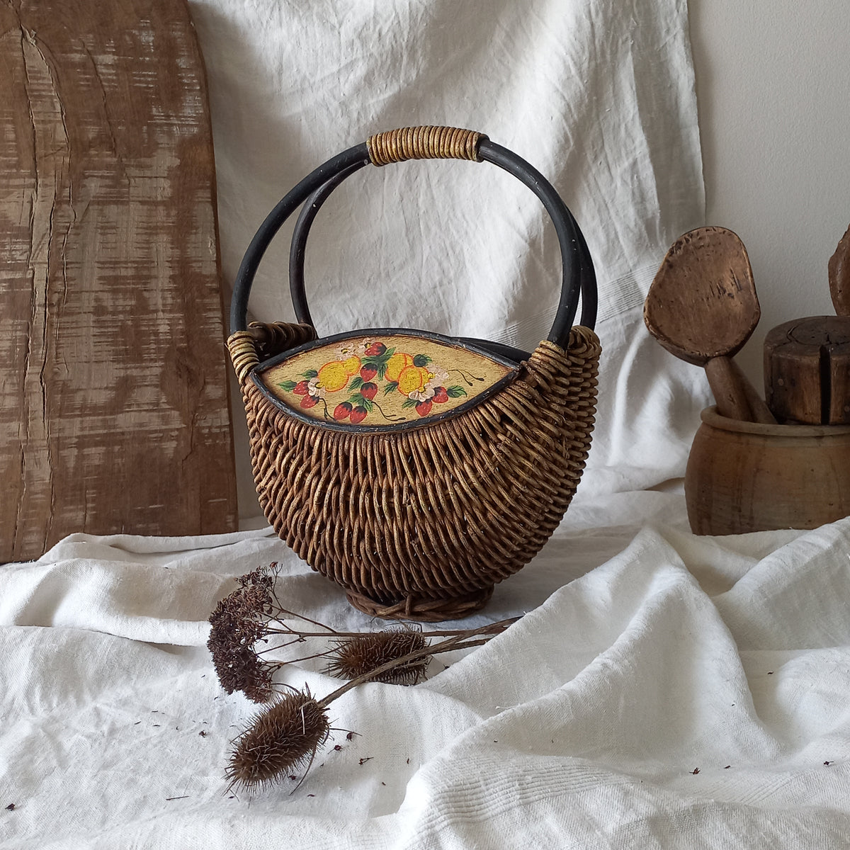 A vintage wicker shopping basket with a small wooden panel on each side with hand-painted fruit - so pretty!

This hand-made piece is full of rustic charm and offers many decorative possibilities to any interior, particularly those of a country, rustic or farmhouse nature.