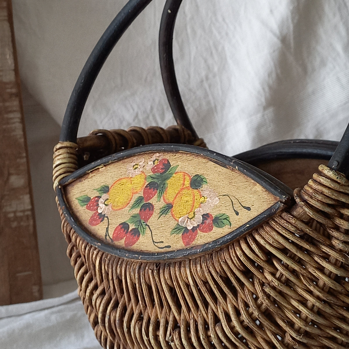 A vintage wicker shopping basket with a small wooden panel on each side with hand-painted fruit - so pretty!

This hand-made piece is full of rustic charm and offers many decorative possibilities to any interior, particularly those of a country, rustic or farmhouse nature.